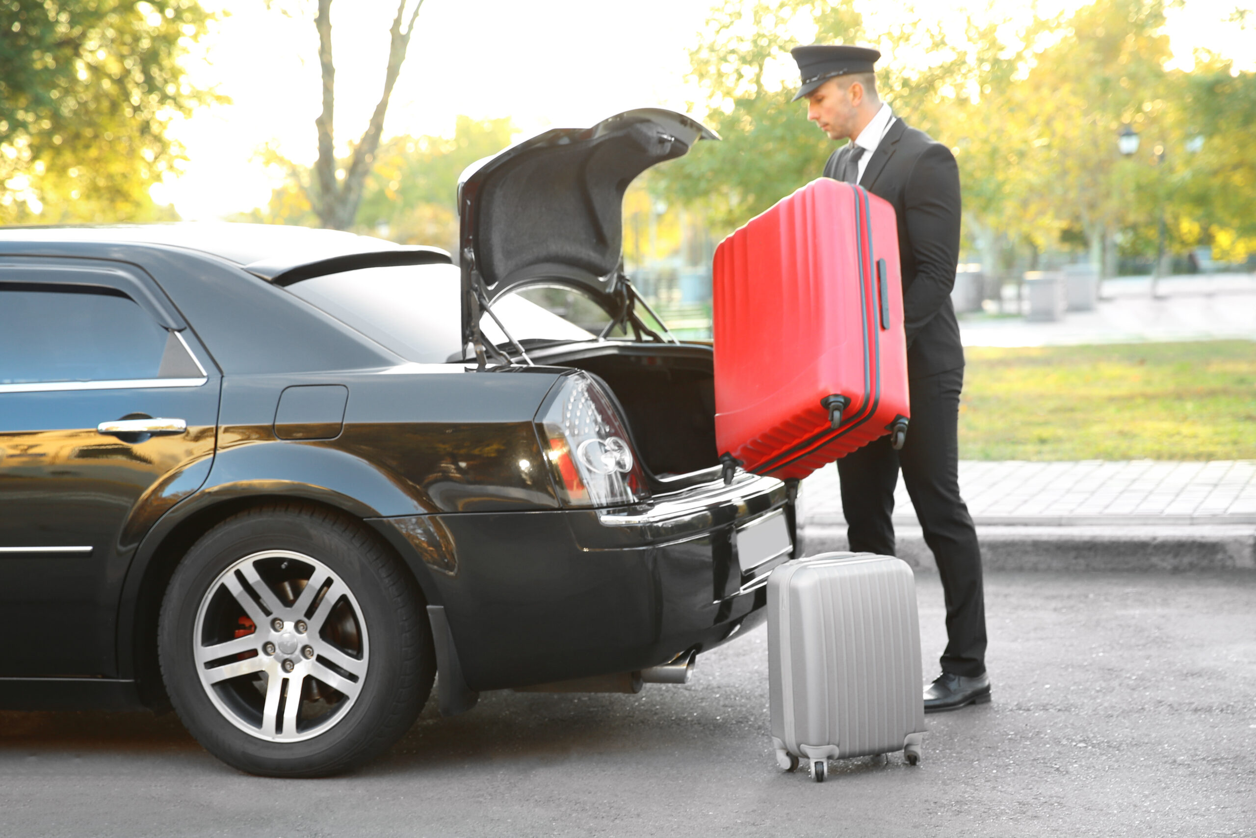 Chauffeur,Putting,Suitcase,In,Car,Trunk Chauffeur,Putting,Suitcase,In,Car,Trunk